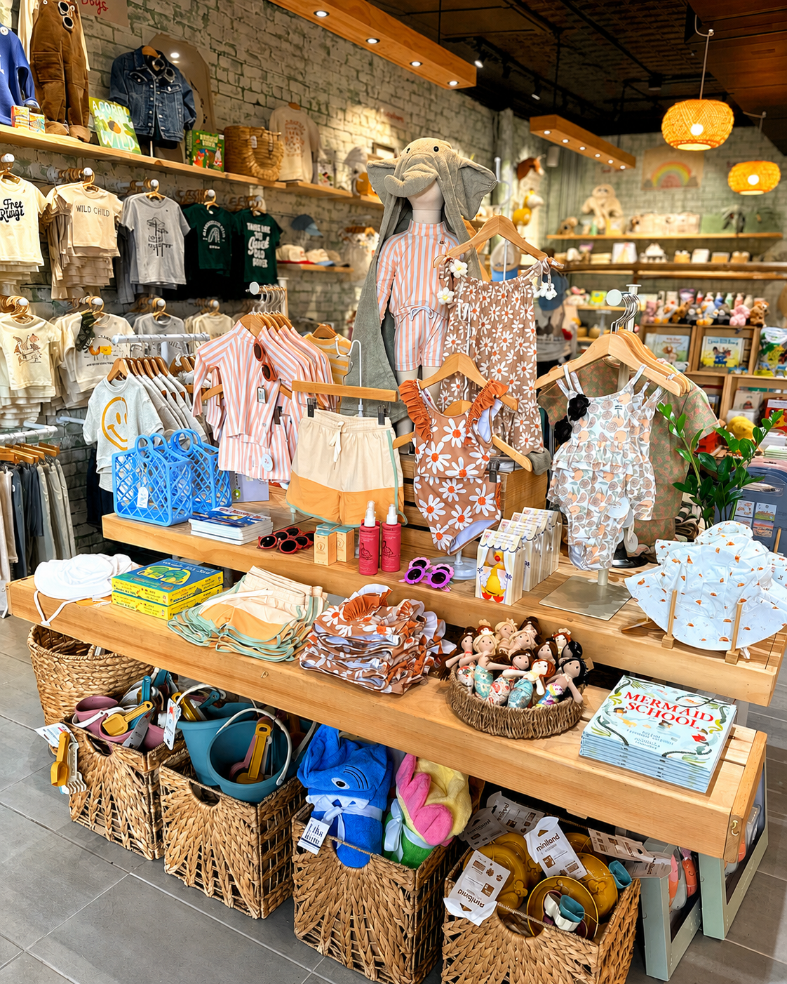 Inside Village Acorn in Warwick, New York, featuring curated baby clothing, children’s books, plush toys, wooden toys, and thoughtful gifts for little ones.